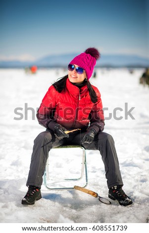 Woman ice-fishing in the winter