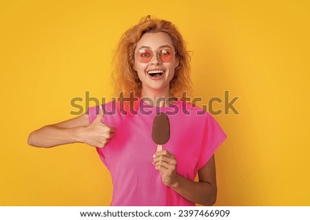 woman with icelolly ice cream in studio, thumb up. woman with icelolly ice cream