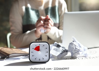 A woman with an impending deadline is crumpling a piece of paper in anger - Shutterstock ID 2226660997