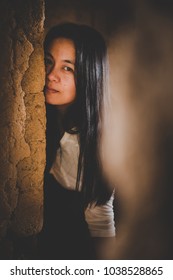 Woman Imprisoned Sneak Peek Or Looking Through The Cap Of Doorway, Assaulted, Victims Of Violence, Anti-violence Concepts.
