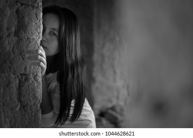 Woman Imprisoned Sneak Peek Or Looking Through The Cap Of Doorway, Assaulted, Victims Of Violence, Anti-violence Concepts.