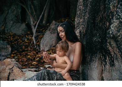 
Woman In Indian Jewelry Plays With Baby