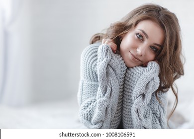 Woman Indoor Portrait. Young Beautiful Woman In Warm Knitted Clothes At Home. Fashion. Autumn, Winter