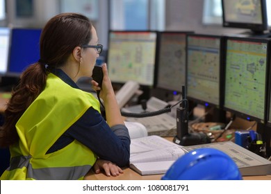 Woman In Industrial Control Room Using Radio To Give Instructions