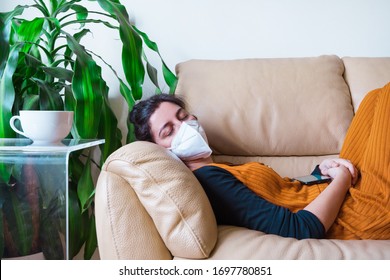 Woman Infected With Coronavirus Disease Sleeping In The Couch At Home. Stay Home. Pandemic Worldwide Virus Disease Covid 19. Health Issues Concept. Sick People With Face Mask To Avoid Contagious.