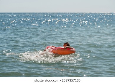 Woman Inflatable Raft Ocean - A woman relaxes and floats on an inflatable raft in the ocean. - Powered by Shutterstock