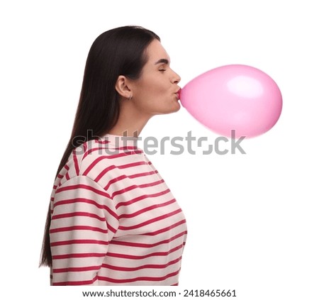 Woman inflating pink balloon on white background