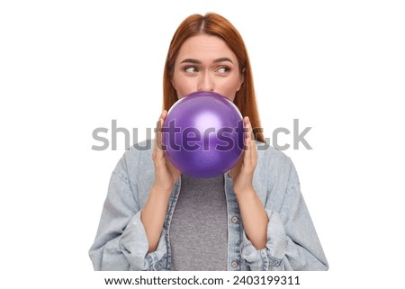 Woman inflating purple balloon on white background