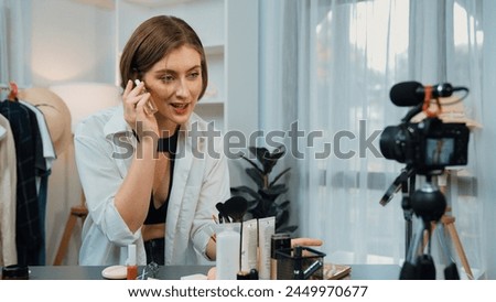 Woman influencer shoot live streaming vlog video review skincare for prim social media or blog. Happy young girl with cosmetics studio lighting for marketing recording session broadcasting online.