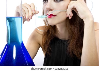 woman inhaling flavored oxygen with cannula and scented water