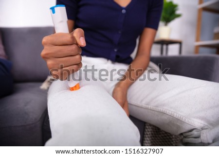 Woman Injecting Epinephrine Using Auto-injector Syringe As An Emergency Treatment For Allergic Reaction 