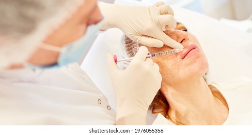 Woman Injecting Hyaluronic Acid On Her Lips As A Dermal Filler For Wrinkle Reduction