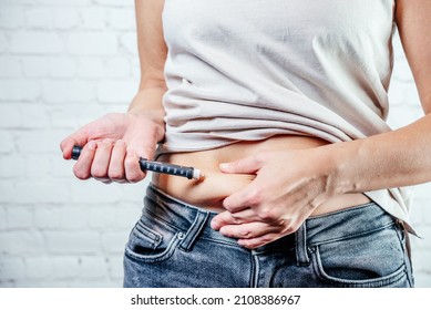 A Woman Injects Insulin With Insulin Injection Device Into The Subcutaneous Tissue Of Abdomen