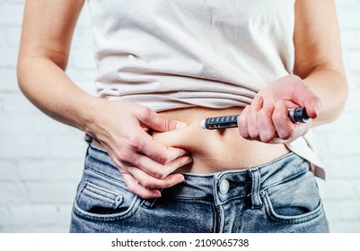 A Woman Injects Insulin With Insulin Injection Device Into The Subcutaneous Tissue Of Abdomen