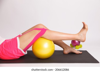 Woman With Injured Knee Doing Physiotherapy Exercise