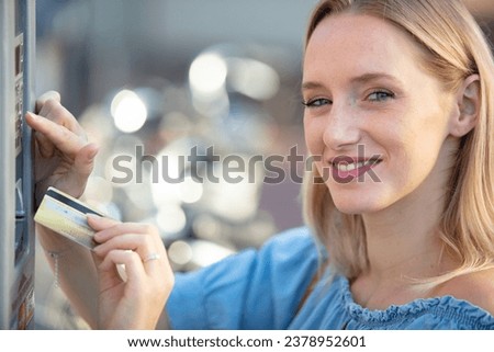 woman inserting bankcard into machine