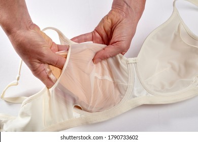 The Woman Inserts Her Silicone Breast Prosthesis Into White Technical Bra.