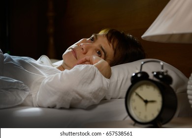 Woman With Insomnia Lying In Bed With Open Eyes