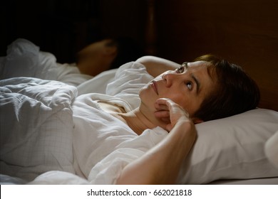 Woman With Insomnia Lying In Bed With Open Eyes