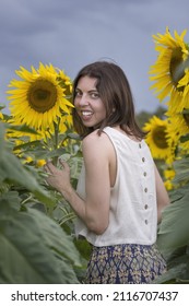 Woman inspecting sunflowers on a farm