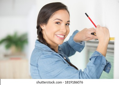 Woman Installing Cassette Roller Blinds On Windows