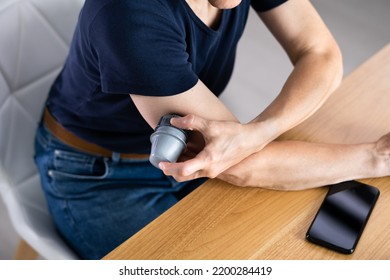 Woman Installing Continuous Glucose Level Monitor On Her Arm - Powered by Shutterstock