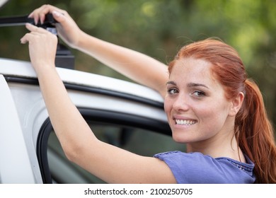 Woman Installing A Roof Rack