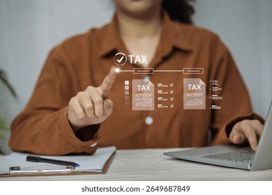 A woman interacts with a futuristic digital interface to process and file different tax documents online.