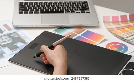 Woman interior designer works on digital graphic tablet with stylus, hand drawing home design project sketches. Creativity and modern technology. - Powered by Shutterstock