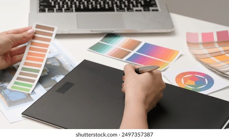 Woman interior designer works on digital graphic tablet with stylus, hand drawing home design project sketches. Creativity and modern technology. - Powered by Shutterstock