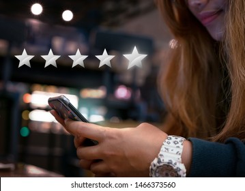 Woman Internet Shopping On Smartphone Submitting 5 Silver Star Satisfaction Feedback - Millennial Girl Replying To Customer Experience Survey Questions By Email - Review, Success & Retention Concept