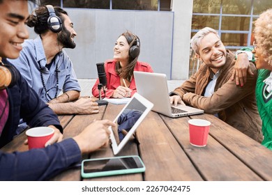 Woman interviewed a man for a podcast outdoors. Young people streaming with casual studio broadcasting. High quality photo - Powered by Shutterstock