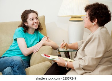 Woman Interviewing A Teen Girl For College Admission Or Job.  Could Also Be Counseling Session.