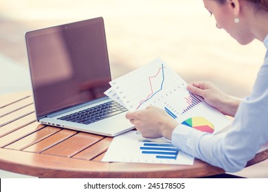 woman investment consultant analyzing company annual financial report balance sheet statement working with documents graphs. Stock market, office, tax, education concept. Hands with charts papers
