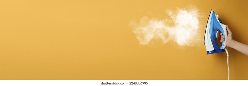 Woman with iron on orange background, closeup. Banner design with space for text
