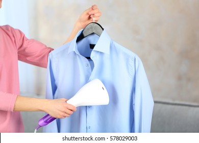 Woman Ironing Shirt With Garment Steamer