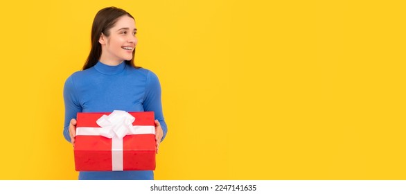 Woman isolated face portrait, banner with copy space. seasonal sales. smiling girl with box on yellow background. boxing day. present and gifts buy. - Shutterstock ID 2247141635