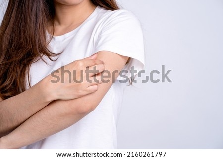 A woman with itching scratching her arms skin caused by eczema, allergic skin, dermatitis and insect bites. Dermatitis.