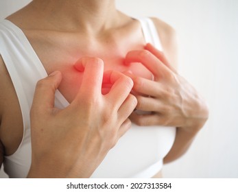 Woman itching and scratching her chest caused by insect bites, allergies and skin diseases. health concepts. closeup photo, blurred.