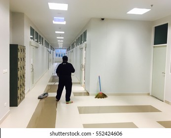 Woman Janitor Mopping Floor In Classroom Hallway At School. Commercial Cleaning Service In Office Building Concept. 