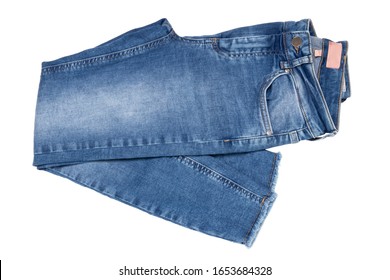 Woman jeans isolated. Folded trendy stylish female blue jeans trousers isolated on a white background. Fashionable denim pants for women.