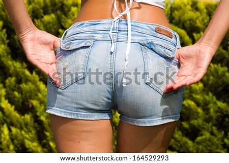 Woman in jeans shorts at the park