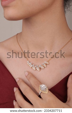 Woman Jewelery concept. Woman’s hands close up wearing rings and necklace modern accessories