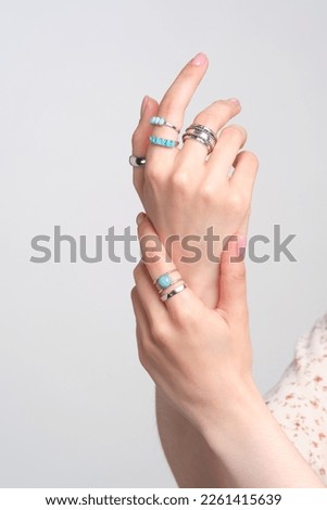 Woman Jewelery concept. Woman s hands close up wearing rings and necklace modern accessories elegant life style with copy space for text and background.