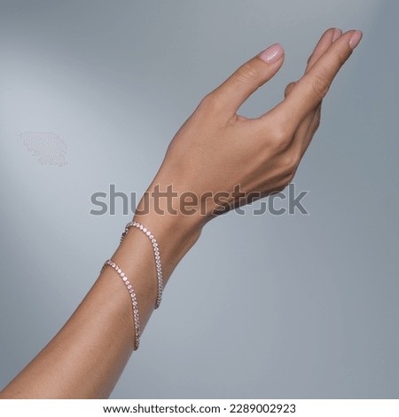 Woman Jewelery concept. Woman s hands close up wearing rings and necklace modern accessories elegant life style with copy space for text and background.