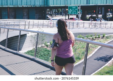 Woman Jogging on crossing overpass to Charles River esplanade in the summer at Boston, USA.