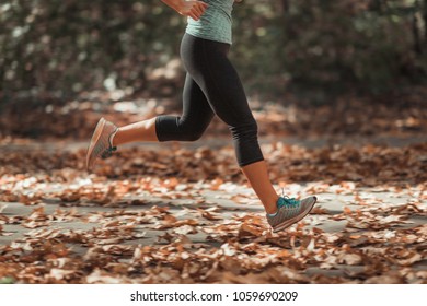 Woman Jogging Outdoors In Autumn