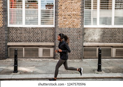 Woman Jogging Through The City