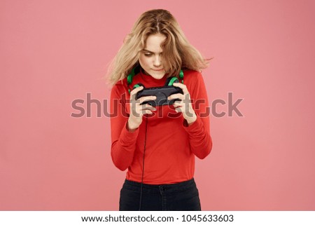  woman with joystick on pink background                              