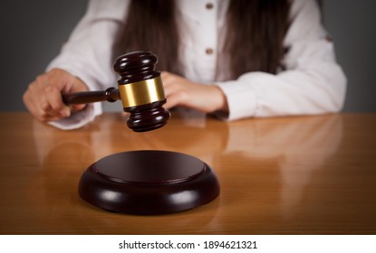 Woman Judge. Judge's Hammer. Wooden Table.